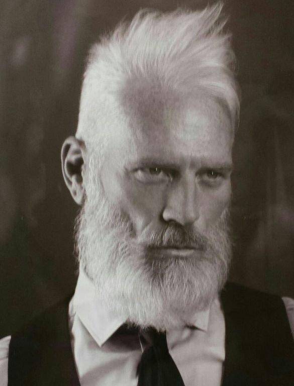 Ritratto in bianco e nero di uomo con barba piena e capelli brizzolati